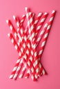 Red and white striped paper straws on a pink background Royalty Free Stock Photo