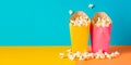 A red and white striped popcorn bucket full of fluffy, buttery popcorn, bold colors of background Royalty Free Stock Photo