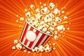 Exploding Popcorn Bucket with Red Stripes on Orange Background Royalty Free Stock Photo