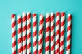 Red and white striped straws on a teal background Royalty Free Stock Photo