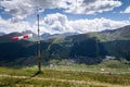 Red and white striped windsock dramatic clouds mountains in background Royalty Free Stock Photo