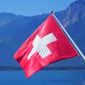 Red and white Swiss national flag at of Lake Geneva in Switzerland Royalty Free Stock Photo