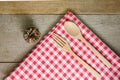 Red and white tablecloth, wooden spoons on wood table Royalty Free Stock Photo