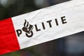 Red and white tape of Dutch police (politie) at incident