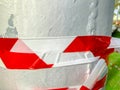 Red white tape to prohibit twisting the stab in the street. Close up shot Royalty Free Stock Photo