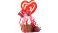 Colorful novelty cupcake decorated with candy and large heart shaped lollipop