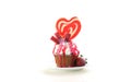 Colorful novelty cupcake decorated with candy and large heart shaped lollipop