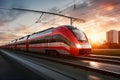 A red and white train traveling down train tracks. High-speed suburban train at sunset Royalty Free Stock Photo