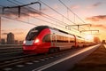 A red and white train traveling down train tracks. High-speed suburban train at sunset Royalty Free Stock Photo