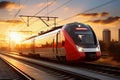 A red and white train traveling down train tracks. High-speed suburban train at sunset Royalty Free Stock Photo