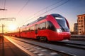 A red and white train traveling down train tracks. High-speed suburban train at sunset Royalty Free Stock Photo