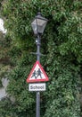 School warning sign on street lamp