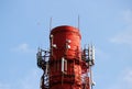 Red and white tube boiler with cables of telecommunications equipment, primarily for cellular transmission