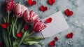 Red and white tulips with a blank card mock-up with space for text and heart-shaped petals on grey concrete background Royalty Free Stock Photo