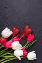 Red and white tulips flowers and decortive hearts on black text
