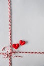 Red white twine tied in bow with hearts ,christmas, valentines day  wrap decoration , package rope on white background Royalty Free Stock Photo