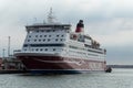 Red and white Viking Line ferry is moored in port.