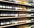 Red and White vine bottles mockup on shelves in supermarket. Royalty Free Stock Photo