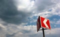 Red and white warning arrow on cloudy sky background Royalty Free Stock Photo