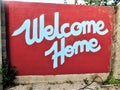 Red and white welcome home sign