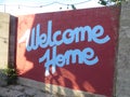 Red and white welcome home sign