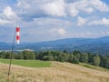 Red And White Wind Cone In A Hilly Landscape