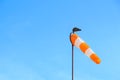 Red-white wind sock on the blue sky background Royalty Free Stock Photo