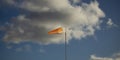 Red-white windsock against the blue sky, windy Royalty Free Stock Photo