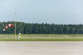 Red and white windsock at an airport runway Royalty Free Stock Photo