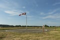 Red and white windsock wind filled blue sky background Royalty Free Stock Photo