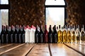 red and white wine bottles neatly lined up on a table Royalty Free Stock Photo