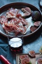 Red and white wine and bruschetta with bacon on a dinner table