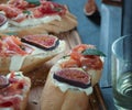 Red and white wine and bruschetta with bacon on a dinner table Royalty Free Stock Photo