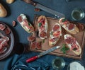 Red and white wine and bruschetta with bacon on a dinner table Royalty Free Stock Photo