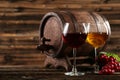 Red and white wine glass with bottle and barrel on the brown wooden background Royalty Free Stock Photo