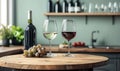 Red and white wine glasses, bottle, grapes on kitchen table Royalty Free Stock Photo