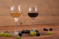 Red and white wine glasses and grape on wooden table Royalty Free Stock Photo