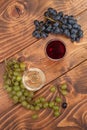 Red and white wine glasses and grape on wooden table Royalty Free Stock Photo
