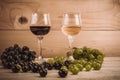 Red and white wine glasses and grape on wooden table Royalty Free Stock Photo