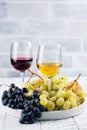 Red and white wine in glasses with grapes Royalty Free Stock Photo