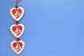 Red and white wooden hearts on a blue-blue background