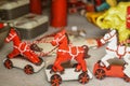 Red and white wooden horse toy for sale in a traditional handicraft store during Christmas market Royalty Free Stock Photo