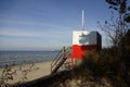 Red and white wooden lifeguard cabin with a stair on an empty sandy beach in Pirita. Empty beach with no people on a Royalty Free Stock Photo