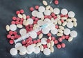 Red, white, yellow drugs pills with syringe, powder, bunch