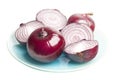 Red whole and sliced onion on a plate , isolated on white background Royalty Free Stock Photo