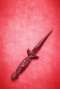 Red Wiccan dagger on a red background