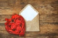 Red wicker heart with roses, envelope with blank note Royalty Free Stock Photo