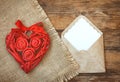 Red wicker heart with roses, ribbon, envelope Royalty Free Stock Photo