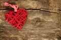 Red wicker heart on wooden background