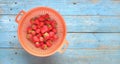 Red wild strawberries on old blue wooden table, flat lay Royalty Free Stock Photo